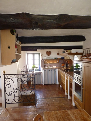 Up a couple of stairs into the open plan kitchen and dining room. The Provençal kitchen has all modern utilities- oven, induction cooktop, dishwasher, microwave, nespresso machine etc decorated in Provençal style