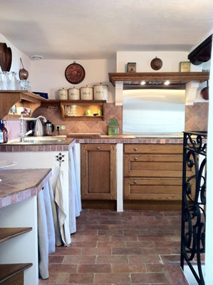 Up a couple of stairs into the open plan kitchen and dining room. The Provençal kitchen has all modern utilities- oven, induction cooktop, dishwasher, microwave, nespresso machine etc decorated in Provençal style